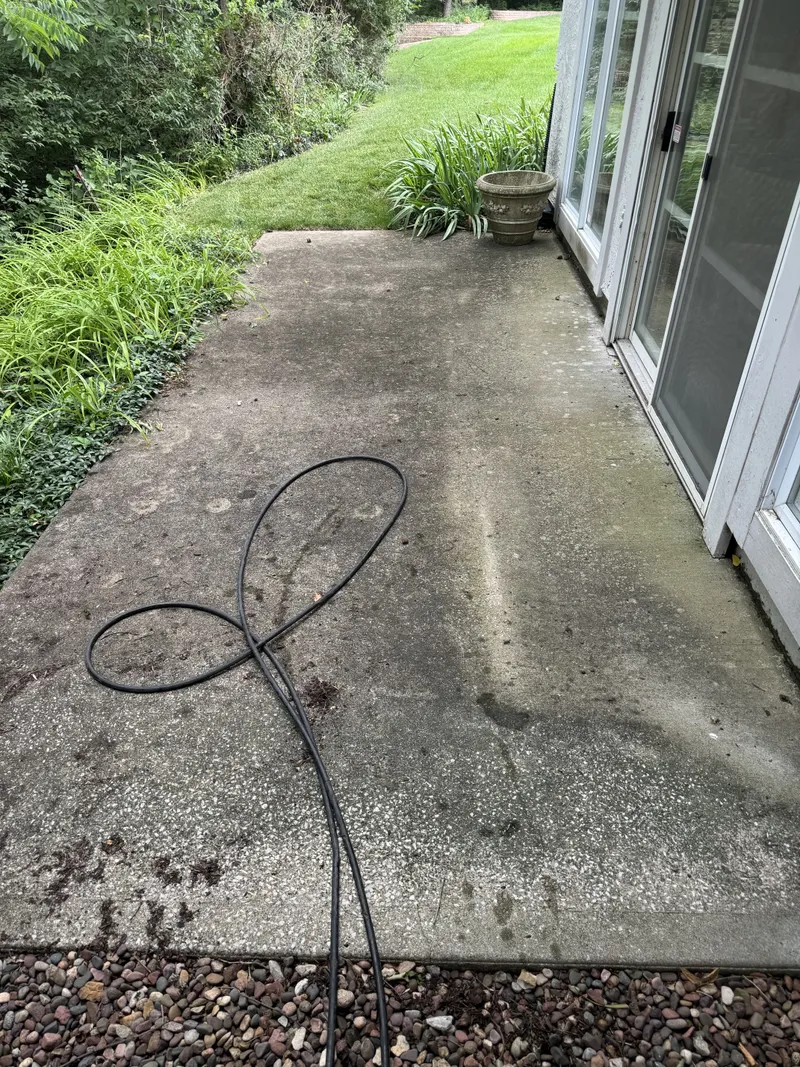 Pressure washing service by Sparkle Window Cleaners — Driveway mid-wash; dirty section clearly visible