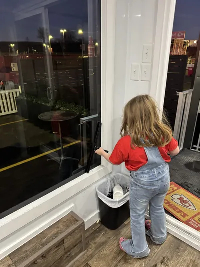 Professional window cleaning by Sparkle Window Cleaners — Isla cleaning a sliding glass door with a bucket