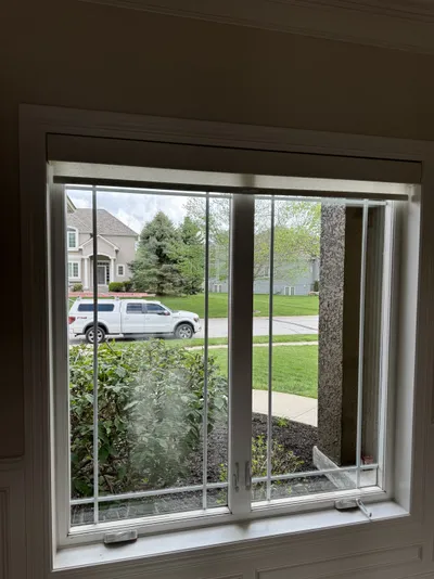 Professional window cleaning by Sparkle Window Cleaners — Clean sliding window, neighborhood view.
